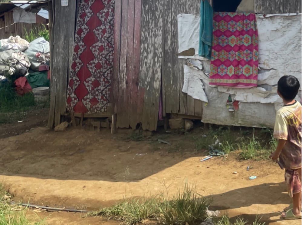 A young boy walks past homes in Papandayan, Marawi City.